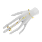 Luxury gold and diamond hand chain bracelet set on a mannequin hand against a white background