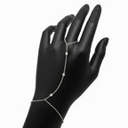 Stone Path Hand Chain Bracelet in Sterling Silver and 18K White Gold on a black mannequin hand against a white background