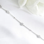 Silver chain with small round stones on a white background