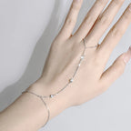 Hand wearing a luxury Stone Path Hand Chain Bracelet in Sterling Silver and 18K White Gold 