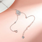 Hand Chain Bracelet clasp in Sterling Silver and white gold with heart charm on a soft pink background