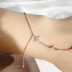 Stone Twilight Hand Chain Bracelet in rose 14k gold on a person's wrist against a neutral background