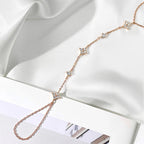 Stone Twilight Hand Chain Bracelet in rose 14k gold on a white fabric background